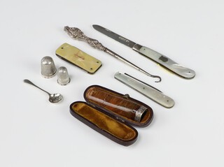 A silver and mother of pearl fruit knife Sheffield 1922, 1 other, a button hook, 2 thimbles, a spoon and pocket knife, together with a mounted cigar holder (a/f) 