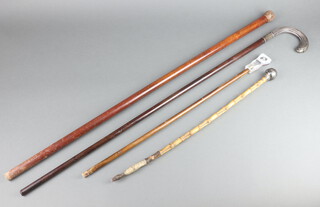 A Continental walking stick with white metal handle, a cane swagger stick and stick 