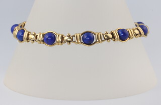 A yellow metal 750 cabochon lapis lazuli bracelet, gross weight 19 grams (1 stone missing), 20cm 