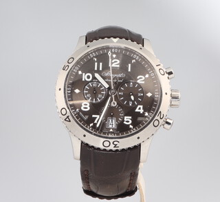 A Breguet steel cased chronograph wristwatch, in a 38mm case, the dial inscribed Retour En Vol with 3 subsidiary dials and calendar aperture with a black face and white numerals, the case numbered 94369 3810 on a black leather strap with steel mounts, complete with original leather bound box, outer box containing warranty certificate and 3 pamphlets and Breguet invoice 2012