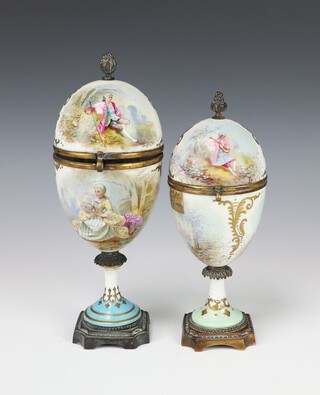 A 19th Century Sevres gilt metal mounted porcelain egg shaped cup and cover decorated with figures and landscapes, having a gilt metal floral finial, signed Luigi, 22cm, a similar ditto 20cm 