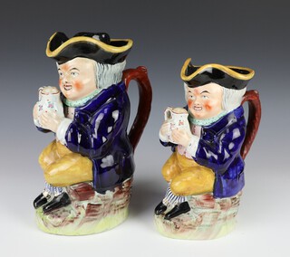 19th Century Staffordshire Toby jug of a seated man holding a mug of beer with original hat 25cm, ditto (no hat) 23cm 