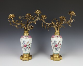A pair of famille rose style oviform porcelain vases decorated with flowers having gilt metal bases and gilt metal rustic 3 light candle holders 40cm  