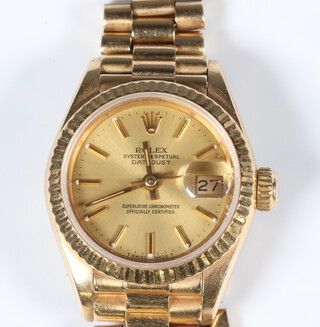 A lady's 18ct yellow gold Rolex Oyster Perpetual Datejust wristwatch on a 18ct yellow gold President bracelet, contained in a 25mm case, engraved to the reverse with presentation inscription dated 1989, together with 3 extra links 