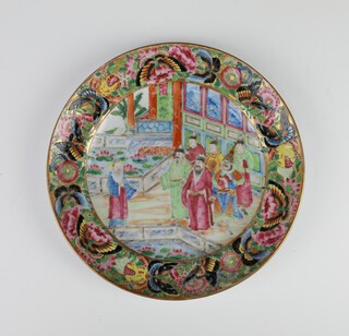 An 18th Century Chinese famille rose plate decorated with figures on a pavilion terrace enclosed by insects and flowers 20cm 