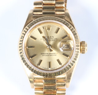 A lady's 18ct yellow gold Rolex Oyster Perpetual Datejust wristwatch on a 18ct yellow gold President bracelet, contained in a 25mm case, engraved to the reverse with presentation inscription dated 1987