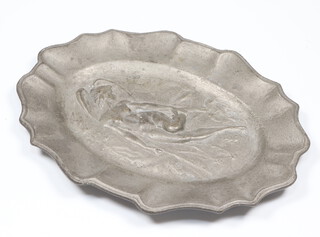 An oval pewter pin tray cast a standing naked angel with French inscription "je n'oublierai jamais, 19th Juin 1897, Gaston Boulet, 14cm x 10cm 