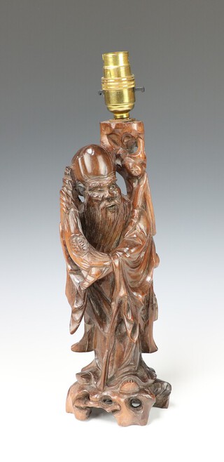 A Chinese pierced and carved hardwood figure of a standing Deity converted to a table lamp 30cm h x 10cm 