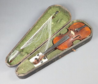 An unlabelled violin with 14" two piece back, complete with bow and contained in a wooden carrying case 