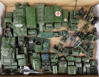 A large collection of Dinky, Corgi and other model military vehicles and field guns to include tank transporters, troop transporters, armoured vehicles and field guns together with a bag of spare wheels, tracks and a small collection of pressed models of World War One field guns and World War One civilians and soldiers  