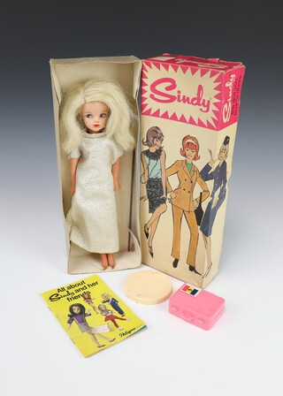 Sindy by Pedigree Dolls, a 1968 Model 12 GSSI Blonde Sindy boxed, blonde hair and cream evening gown with gold fleck, complete with stand, Sindy brochure and pink suitcase   