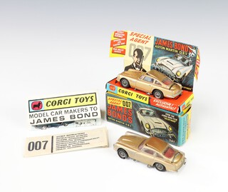 Corgi Toys, a James Bond Goldfinger Aston Martin DB5 in gold no.261, boxed with insert, unsealed secret instructions and folded Corgi brochure, together with 1 unboxed playworn DB5 