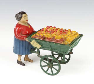 A 1920's French tinplate clockwork toy of a lady fruit seller pushing a fruit cart  