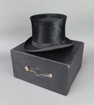 A gentleman's black top hat, the interior marked Extra Quality, size 6 3/4, complete with fibre carrying case  