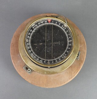 Husun, a maritime compass on a turned wooden base 12cm x 18cm 