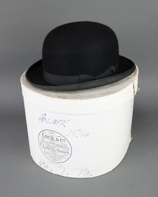 Gieves, Old Bond Street, a gentleman's black bowler hat size 7 1/4, complete with hat box  