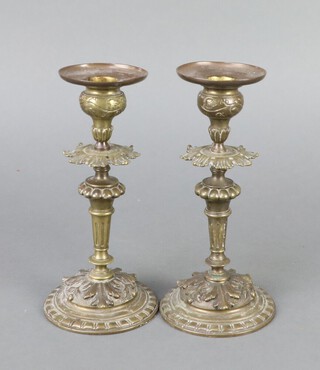 A pair of Victorian gilt bronze candlesticks raised on circular bases 17cm x 8cm diam. 