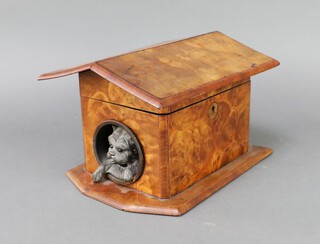 A curious 19th Century walnut cigar/trinket box in the form of a dogs kennel with spelter dog emerging from aperture 16cm x 24cm x 18cm 

