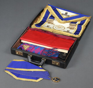 A quantity of Masonic regalia comprising Provincial Grand Officers apron and collar jewel, a Past Master Standard Bearer of Sussex, a Past Masters apron, a Royal Arch Chapter Principals apron and sash, a Royal Arch Chapter Companions apron and sash together with 3 jewels, contained in a black case 