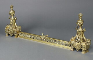 A French 19th/20th Century pierced gilt metal fire curb and irons in the form of lidded urns 46cm h x 116cm w 
