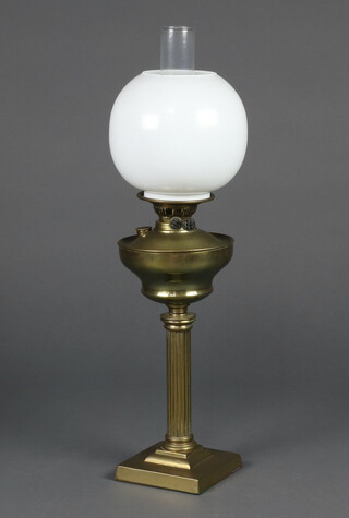 A 19th Century gilt metal oil lamp reservoir on a reeded column and stepped base, complete with opaque glass chimney and shade 68cm h x 14cm