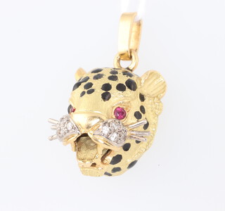 A yellow metal 750 ruby, diamond and enamelled pendant in the form of a leopards head 12.3 grams, 30mm 