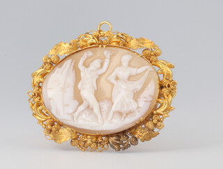 A yellow metal etruscan style oval cameo brooch decorated with dancing figures 4cm, gross weight 6.4 grams