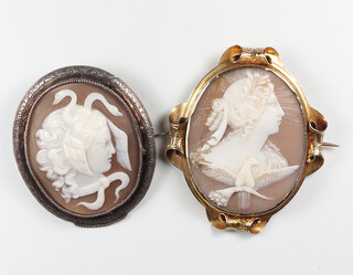 A Victorian yellow metal cameo brooch with a classical lady and dove (cracked), a ditto of Medusa in a white metal mount 