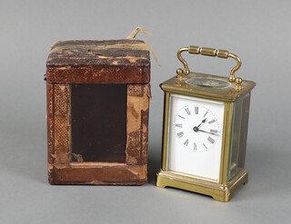 A 19th Century French carriage timepiece with 5cm enamelled dial, Roman numerals contained in a gilt metal case 10cm h x 7.5cm x 6cm, complete with carrying case and key  