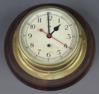 A ward room style clock, the 19cm painted dial with Arabic numerals and sweep second hand, contained in a gilt metal case marked Made in England (no key) 