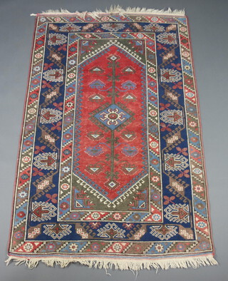 A Persian brown, blue and white rug with central medallion within a multi row border 194cm x 122cm 