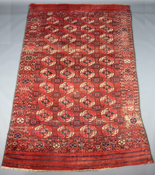A red and blue ground Bokhara rug with 38 octagons to the centre 302cm x 184cm 