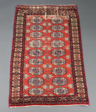 A red and brown ground Bokhara rug with 13 octagons to the centre within a multi row border 132cm h x 79cm w 