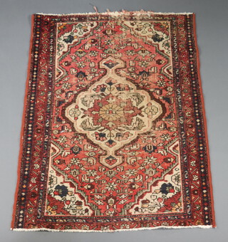 An Afghan red and white ground rug with central medallion 140cm x 107cm 