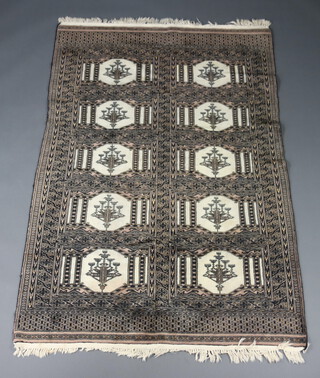 A black and white ground Bokhara rug with 10 medallions to the centre within a multi row border 184cm x 121cm 