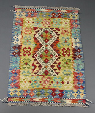 A turquoise, brown and green ground Chobi Kilim with all over geometric design 125cm x 82cm 