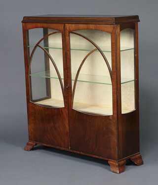 An Art Deco walnut display cabinet, fitted glazed shelves enclosed by astragal glazed panelled doors, raised on splayed bracket feet 120cm h x 105cm w x 32cm d 