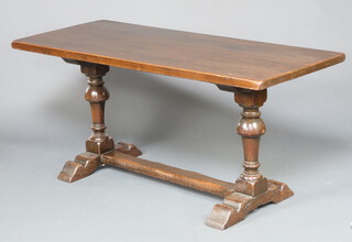 A 17th Century style oak refectory dining table, raised on cup and cover supports with H framed stretcher 77c h x 165cm l x 71cm w 