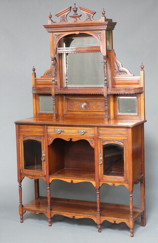 An Edwardian carved walnut chiffonier, the raised mirrored back fitted 2 shelves above 1 long drawer with recess flanked by cupboards enclosed by panelled doors, raised on turned supports with undertier 207cm h x 131cm w x 38cm d 