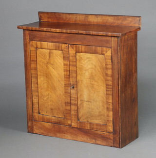A 19th Century mahogany chiffonier with raised back, fitted a shelved interior enclosed by panelled doors, raised on a platform base 92cm h x 89cm w x 31cm d 