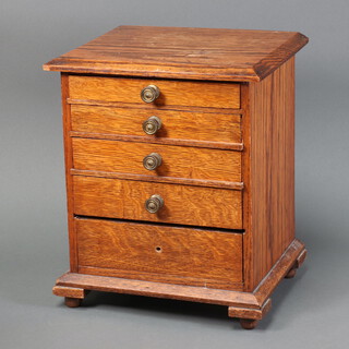 A light oak 5 drawer apprentice style chest on bracket feet 34cm h x 29cm w x 24cm d, with brass handles 