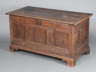 An 18th Century oak coffer of panelled construction with hinged lid, raised on bracket feet 69cm h x 129cm w x 61cm d 