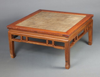 A Chinese square hardwood table with rattan panels to the centre on square supports 50cm h x 97cm 
