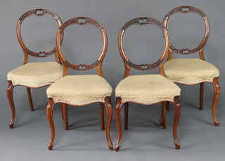 A set of 4 Victorian carved walnut balloon back dining chairs with overstuffed seats on cabriole supports 87cm h x 46cm w x 41cm d 