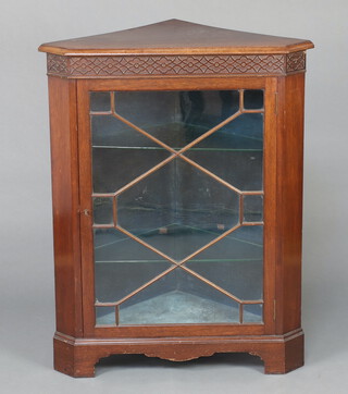 O Baker of Wells Road Bath, an Edwardian Chippendale style mahogany corner cabinet with blind fret work frieze, fitted glazed shelves enclosed by astragal glazed panelled door 106cm h x 84cm w x 59cm d 