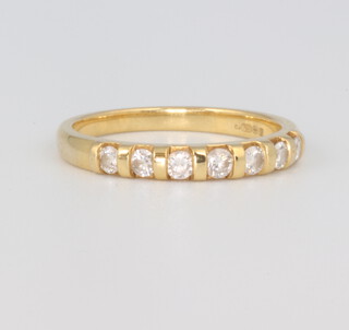 An 18ct yellow gold 7 stone diamond ring, size M 1/2, diamonds approx. 0.03ct each, 3 grams 