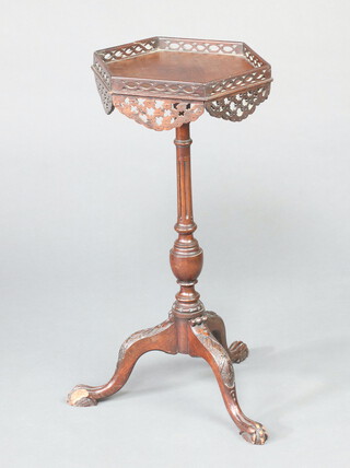 An Edwardian hexagonal Chippendale style wine table with pierced fret, raised on turned column and tripod base 67cm h x 33cm w x 29cm d 