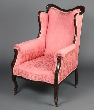 An Edwardian Art Nouveau mahogany show frame chair upholstered in pink material raised on cabriole supports 102cm h x 71cm w x 62cm d 