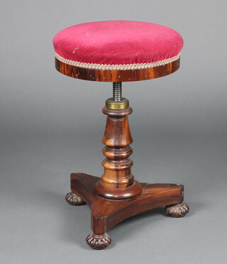 A William IV circular  rosewood adjustable piano stool raised on a turned column, triform base and reeded bun feet 