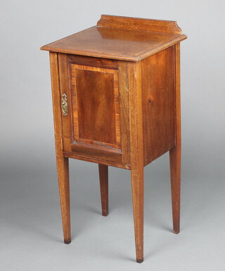 An Edwardian inlaid mahogany bedside cabinet with raised back above a panelled door, on square tapered supports 84cm h x 41cm w x 35cm d 